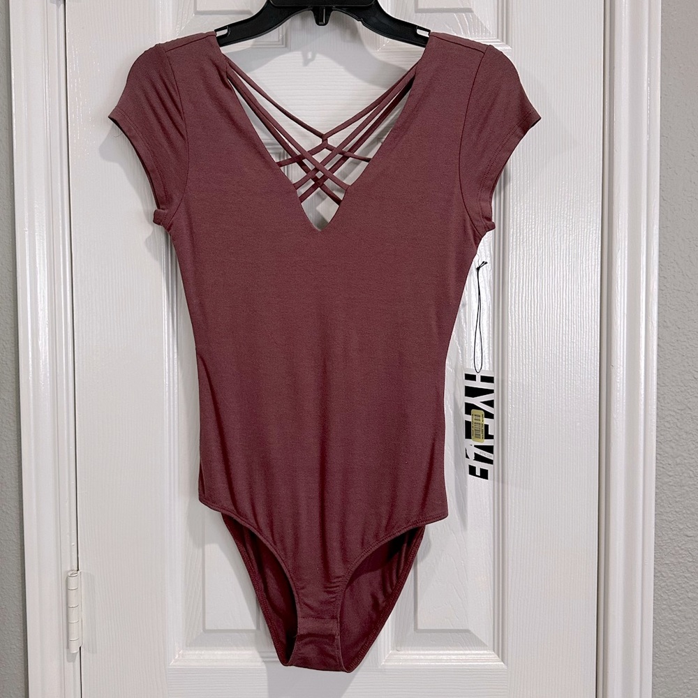 Hyfve bodysuit with snap closure.
